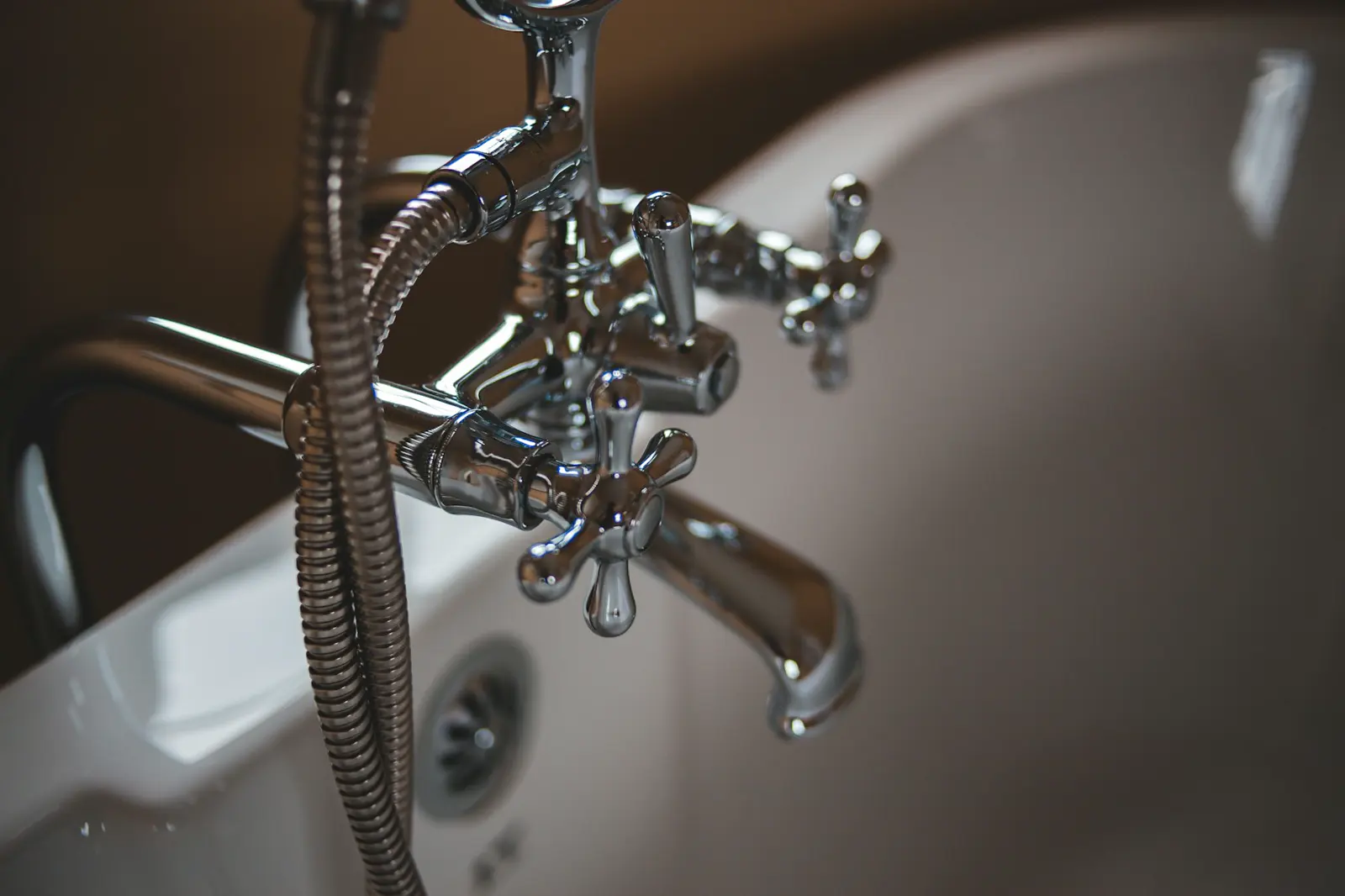Stock photo of copper plumbing fittings and valves on a work surface, used as the San Antonio emergency plumber hero